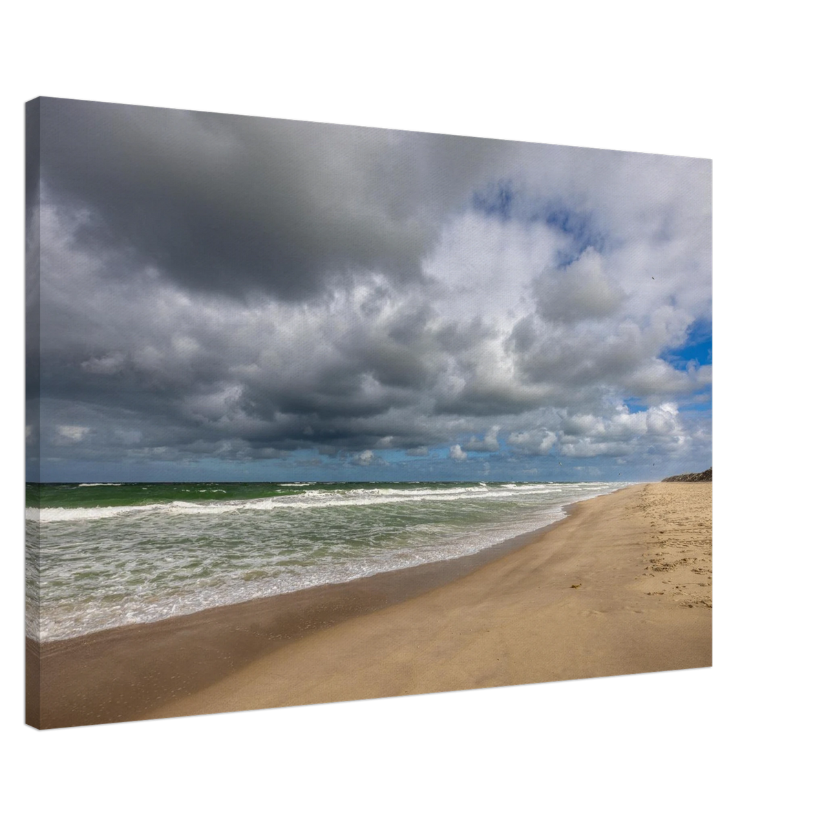 Alttext:
Weite Strandlandschaft in Westerland auf Sylt mit kräftiger Nordseebrandung, aufgewühltem grünblauem Meer, feinem Sandstrand und eindrucksvollen dunklen Wolken unter aufbrechendem blauem Himmel.
